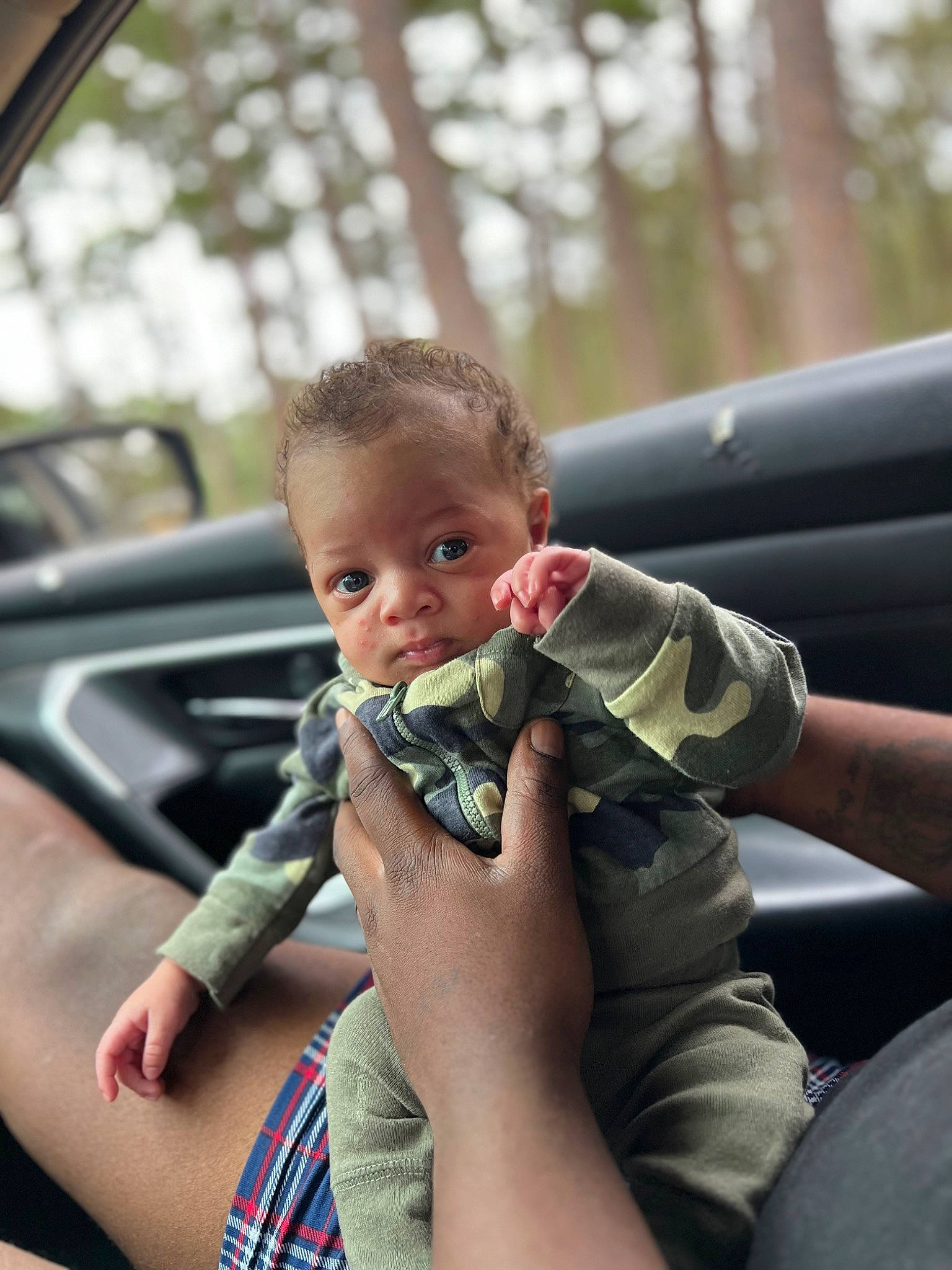 Braelyn is registered to the contest to win money with this photo: arm, auto_part, automotive_exterior, baby, finger, fun, gesture, grass, hand, happy, leg, leisure, motor_vehicle, person, plant, skin, thumb, toddler, tree, vehicle_door