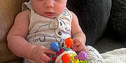 Jace joined the competition — help win amazing prizes! baby, blanket, child, clothing, colorful, comfort, couch, cute, expression, face, feet, hand, home, indoors, infant, person, playtime, sitting, soft, toy