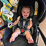 Jace is registered to the contest to win money with this photo: baby, blue_eyes, car_seat, child, child_seat, colorful, cute, foot, happy, indoor, infant, legs, person, playful, plush, safety_harness, seatbelt, smiling, stroller, toy