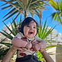 Aaron a rejoint le concours — aidez-le/la à gagner de superbes lots ! baby, blue_sky, child, clothing, cute, dark_hair, greenery, hands, happy, infant, joyful, nature, outdoor, palm_tree, person, playful, portrait, short_sleeve, smiling, sunlight