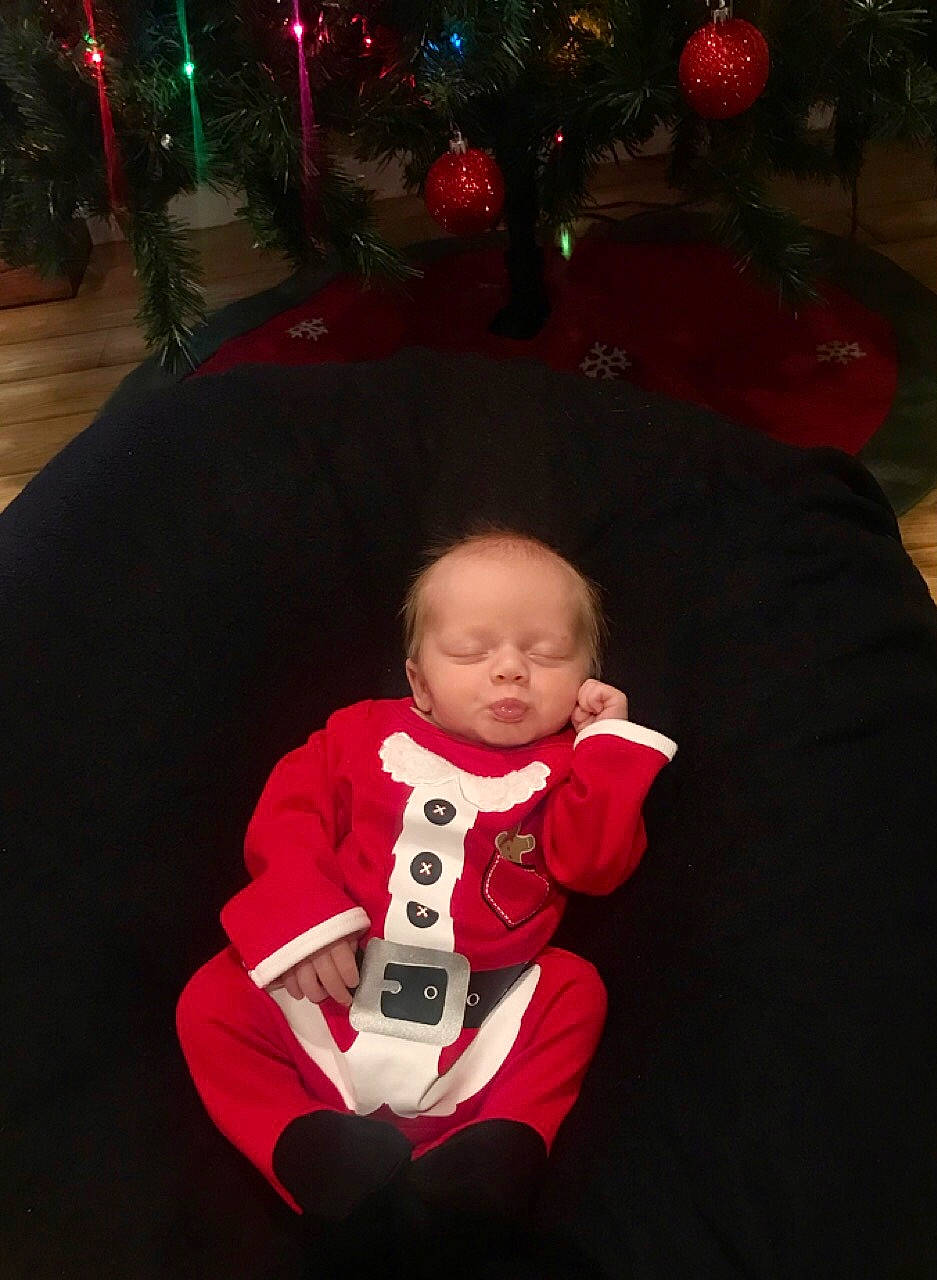 Corbin joined the competition — help win amazing prizes! baby, child, christmas, christmas_eve, christmas_lights, christmas_ornament, christmas_tree, electronic_device, event, fictional_character, head, holiday, lap, night, person, plant, red, sitting, technology, toddler