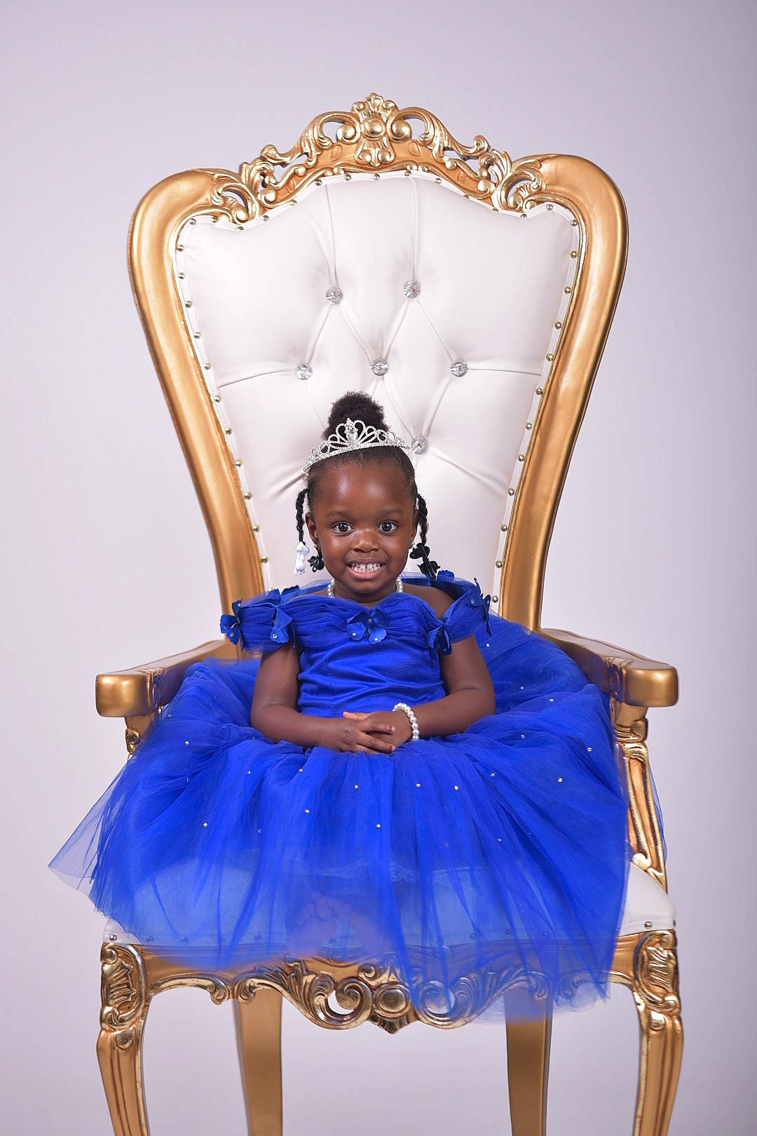 Annah is registered to the contest to win money with this photo: baby_toddler_clothing, chair, child, clothing, dress, electric_blue, event, eye, fashion_accessory, fashion_design, formal_wear, headgear, headpiece, human_body, joy, magenta, person, purple, sitting, sleeve