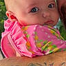 Braelynn is registered to the contest to win money with this photo: baby, child, infant, pink_clothing, floral_pattern, tattoo, arm, face, adult, outdoor, nature, portrait, holding, close_up, expression, curious, cute, bright_colors, person, human