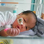 Leo joined the competition — help win amazing prizes! baby, infant, hospital, crib, blanket, medical_tape, nasal_tube, wristband, white_clothing, face, hand, bed, soft_toy, healthcare, newborn, indoors, patient, person, resting, cute