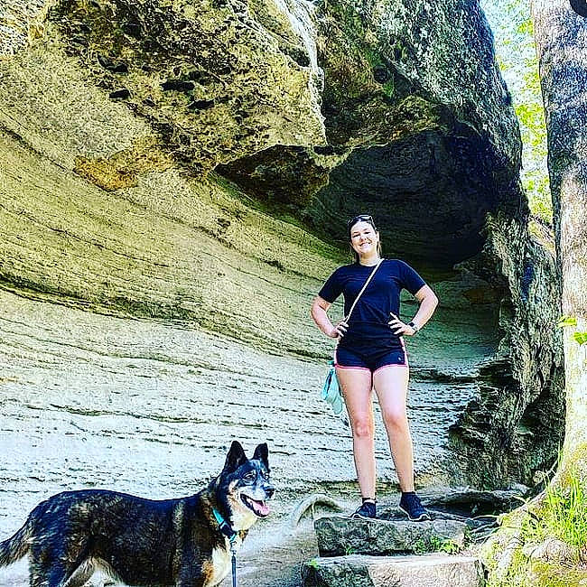 Miska is registered to the contest to win money with this photo: adventure, bedrock, carnivore, dog, dog_breed, dog_hiking, landscape, leash, leg, leisure, mountain, mountainous_landforms, people_in_nature, recreation, rock, shorts, sunglasses, travel, walking, wilderness