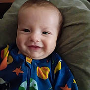 Lucifer joined the competition — help win amazing prizes! baby, infant, smiling, face, onesie, blue_onesie, stars_pattern, planets_pattern, cozy, pillow, blanket, portrait, closeup, cheeks, happy, child, indoor, reclining, newborn, fabric