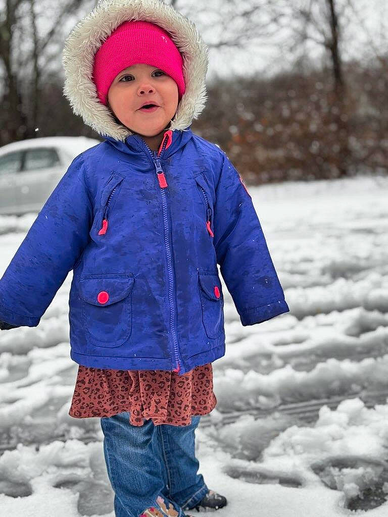 Maryjane is registered to the contest to win money with this photo: cap, child, clothing, electric_blue, face, footwear, freezing, fun, headwear, jacket, magenta, outerwear, person, pink, recreation, sleeve, snow, standing, textile, toddler