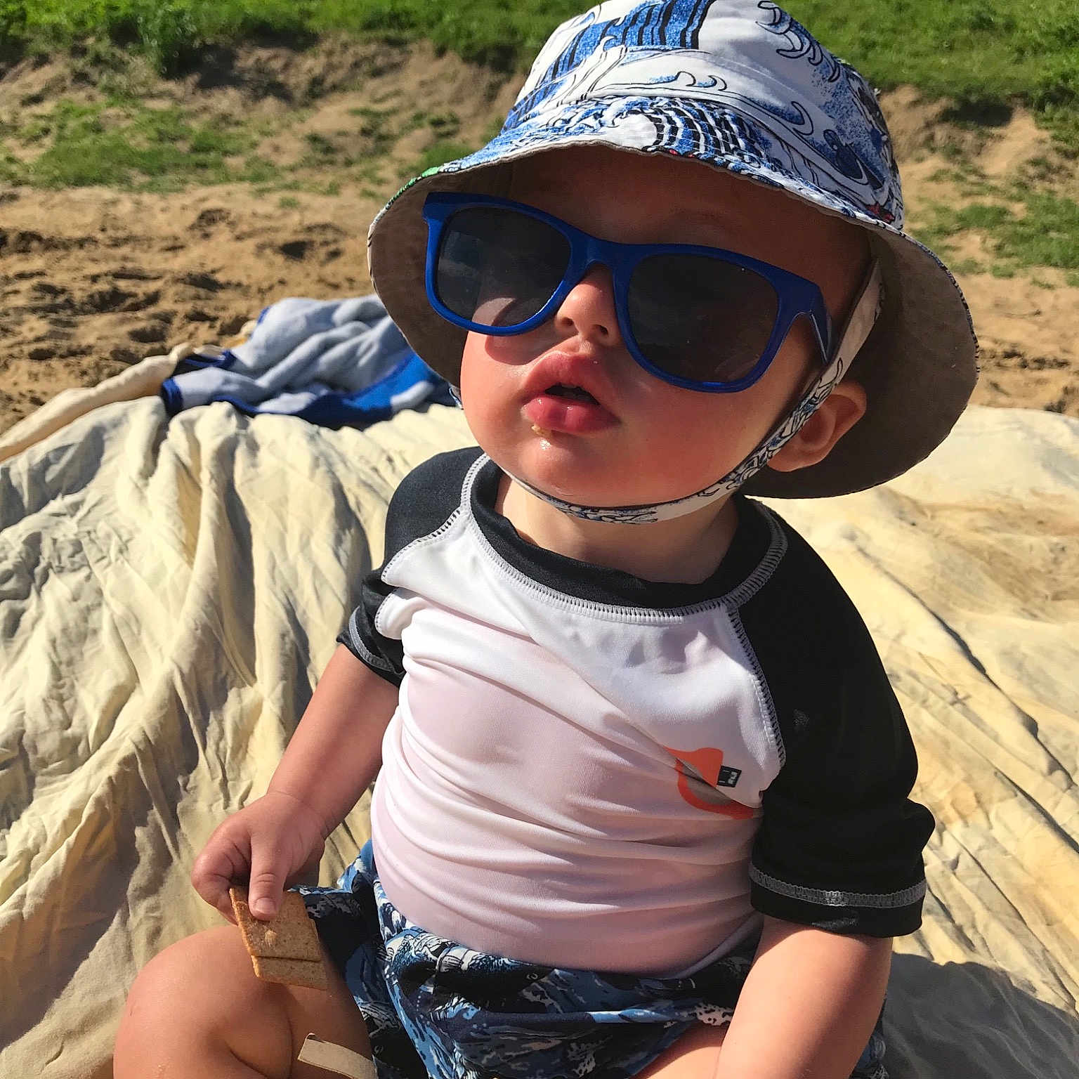 Andy is registered to the contest to win money with this photo: child, cool, eyewear, fun, glasses, goggles, hat, landscape, personal_protective_equipment, recreation, sand, soil, summer, sun_hat, sunglasses, toddler, tourism, vacation, vision_care
