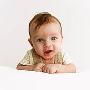 Erik is registered to the contest to win money with this photo: baby, infant, child, face, blue_eyes, smile, hands, curly_hair, cute, portrait, young_child, white_background, soft_lighting, closeup, expression, skin, clothing, front_view, happy, innocence