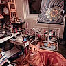 Master Jericho joined the competition — help win amazing prizes! art_supplies, cat, clutter, cozy, crafts, earrings, easel, flower_art, indoor, jewelry, orange_tabby, painting, pen_holder, pet, playful, room, shelves, table, window, wooden_table