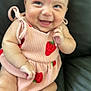 Kailaia is registered to the contest to win money with this photo: baby, infant, smiling, happy, cute, dress, pink, strawberry, pattern, sitting, couch, leather, skin, face, hand, leg, child, indoor, portrait, person