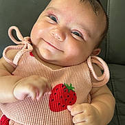 Kailaia joined the competition — help win amazing prizes! baby, child, smiling, cute, infant, pink_dress, strawberry_pattern, hand, face, portrait, indoors, couch, happy, skin, short_hair, clothing, person, sitting, young, closeup