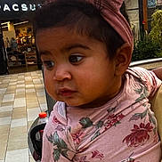 Cecelia joined the competition — help win amazing prizes! toddler, child, baby, headband, pink, floral_shirt, indoor, mall, shopping_center, person, curious, holding, clothing, portrait, cute, young, skin, face, hair, expression