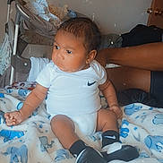 Lakendrick Jr. joined the competition — help win amazing prizes! baby, infant, child, blanket, elephant_pattern, clothing, nike, socks, shoes, indoor, person, arm, stroller, wall, door, butterfly_emoji, expression, sitting, support, portrait