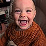 Eloise joined the competition — help win amazing prizes! baby, child, smiling, happy, face, knit_sweater, orange, indoor, seat, baby_seat, closeup, portrait, cute, infant, person, apparel, happy_expression, young_child, cozy, warm_clothing