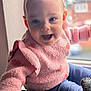 baby, child, smiling, pink_sweater, ruffle_sleeves, window, natural_light, happy, indoor, portrait, cute, soft_texture, cozy, young_child, person, face, blue_pants, sitting, home, infant