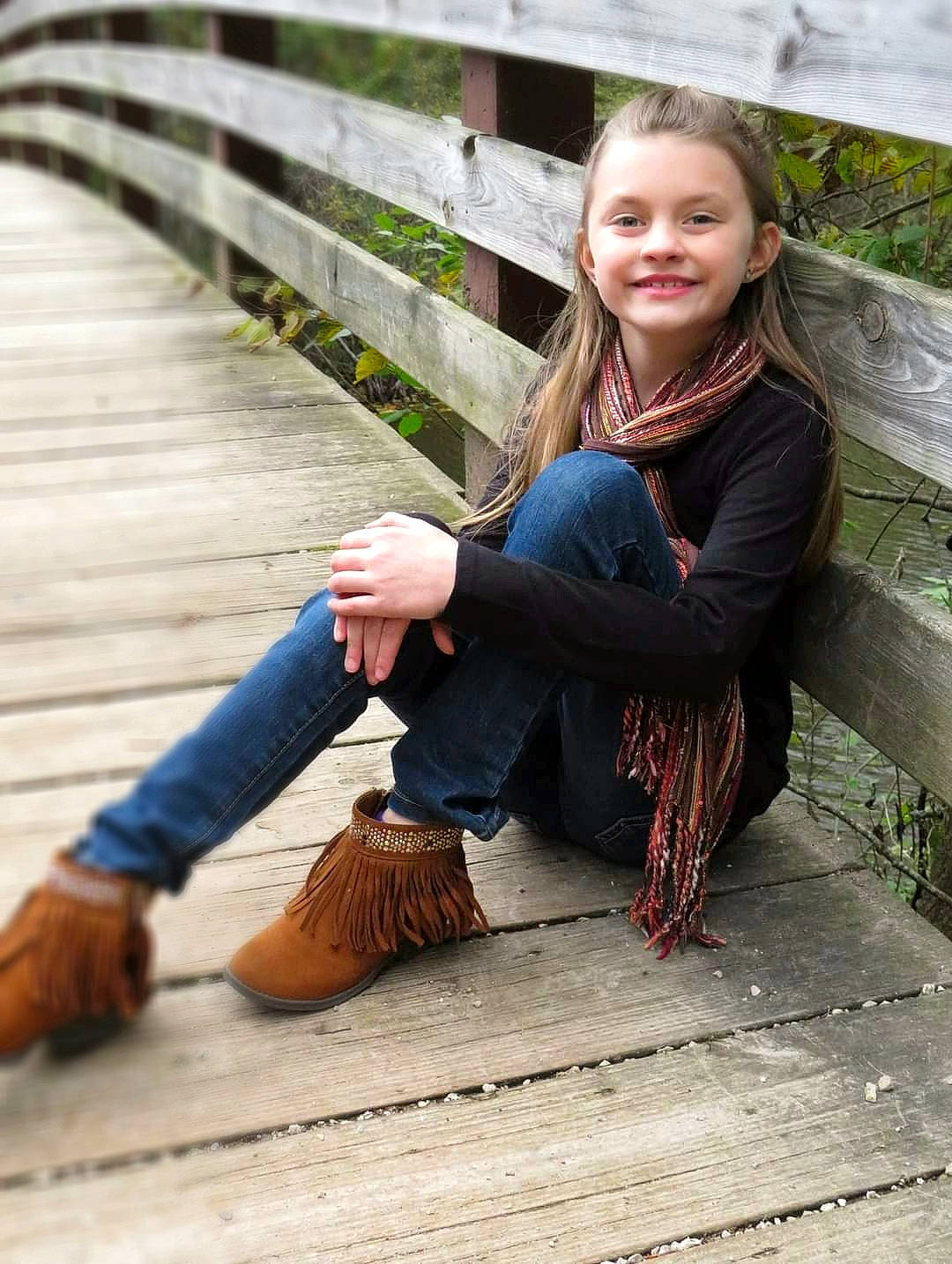 Brylee joined the competition — help win amazing prizes! boot, child, child_model, footwear, happy, jeans, joy, leg, long_hair, outerwear, person, photograph, photography, shoe, sitting, smile, toddler, tree, wood