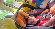 Luca is registered to the contest to win money with this photo: child, toddler, car_seat, plush_toys, pikachu, blue_mouse, car_interior, seatbelt, smiling, red_clothing, sunroof, window, daylight, safety_harness, toy, cute, happy, travel, road_trip, car
