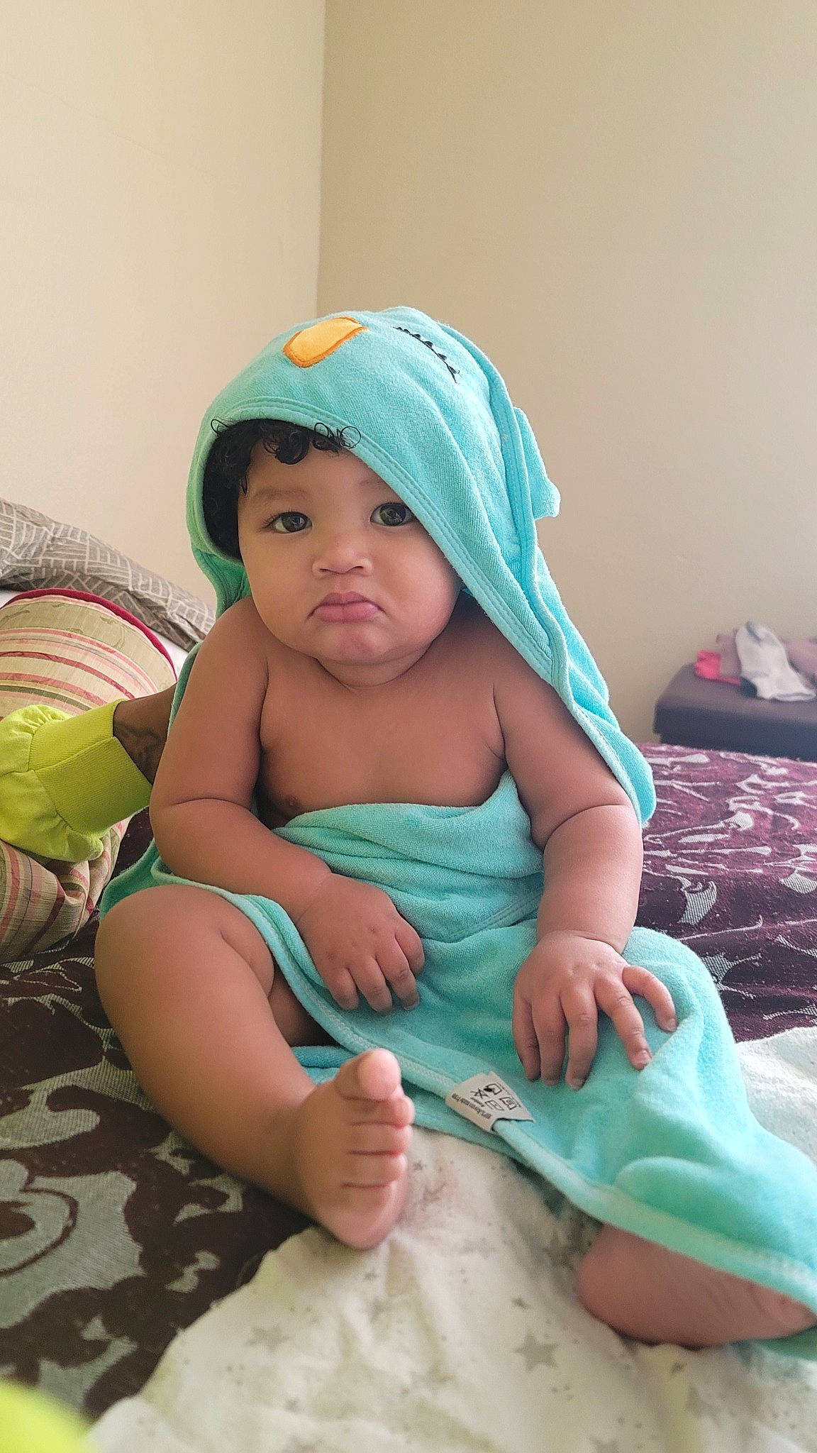 Chosen is registered to the contest to win money with this photo: abdomen, aqua, baby, baby_products, baby_toddler_clothing, baseball_cap, cap, chair, child, comfort, fashion_accessory, fun, hat, headwear, linens, mechanical_fan, person, pink, sitting, skin