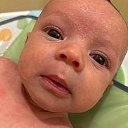 Anakin joined the competition — help win amazing prizes! baby, closeup, face, skin, eyes, infant, child, eyelashes, wet_skin, curious, portrait, indoors, padded_surface, head, newborn, expression, human, person, soft_light, colorful_background