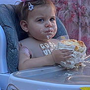 Aurora is registered to the contest to win money with this photo: baby, birthday, cake, crown, high_chair, frosting, face_paint, party, celebration, child, tattoo, woman, dress, decorations, flowers, ribbons, pink, white, blue, happy