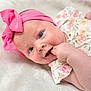baby, infant, child, headband, pink, bow, hand, finger, blue_eyes, face, skin, clothing, floral, pattern, blanket, soft, portrait, lying_down, cute, smiling