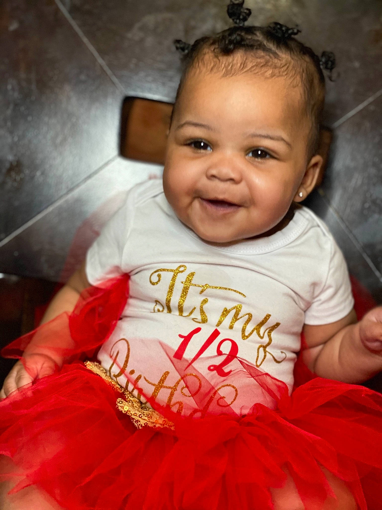 Zaelyn is registered to the contest to win money with this photo: baby, baby_toddler_clothing, cheek, chin, dress, eyebrow, finger, flash_photography, gesture, happy, head, iris, joy, lip, mouth, nose, organ, person, pink, skin