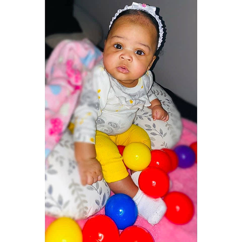 Zaelyn is registered to the contest to win money with this photo: arm, baby, baby_playing_with_toys, baby_products, baby_toddler_clothing, balloon, child, clothing, electric_blue, event, fun, happy, leisure, organ, party_supply, person, product, sleeve, t_shirt, toddler