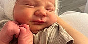 Roman is registered to the contest to win money with this photo: newborn, baby, infant, sleeping, hat, fuzzy, bear_ears, arm, skin, clothing, closeup, indoor, person, child, cute, peaceful, face, hand, soft, portrait