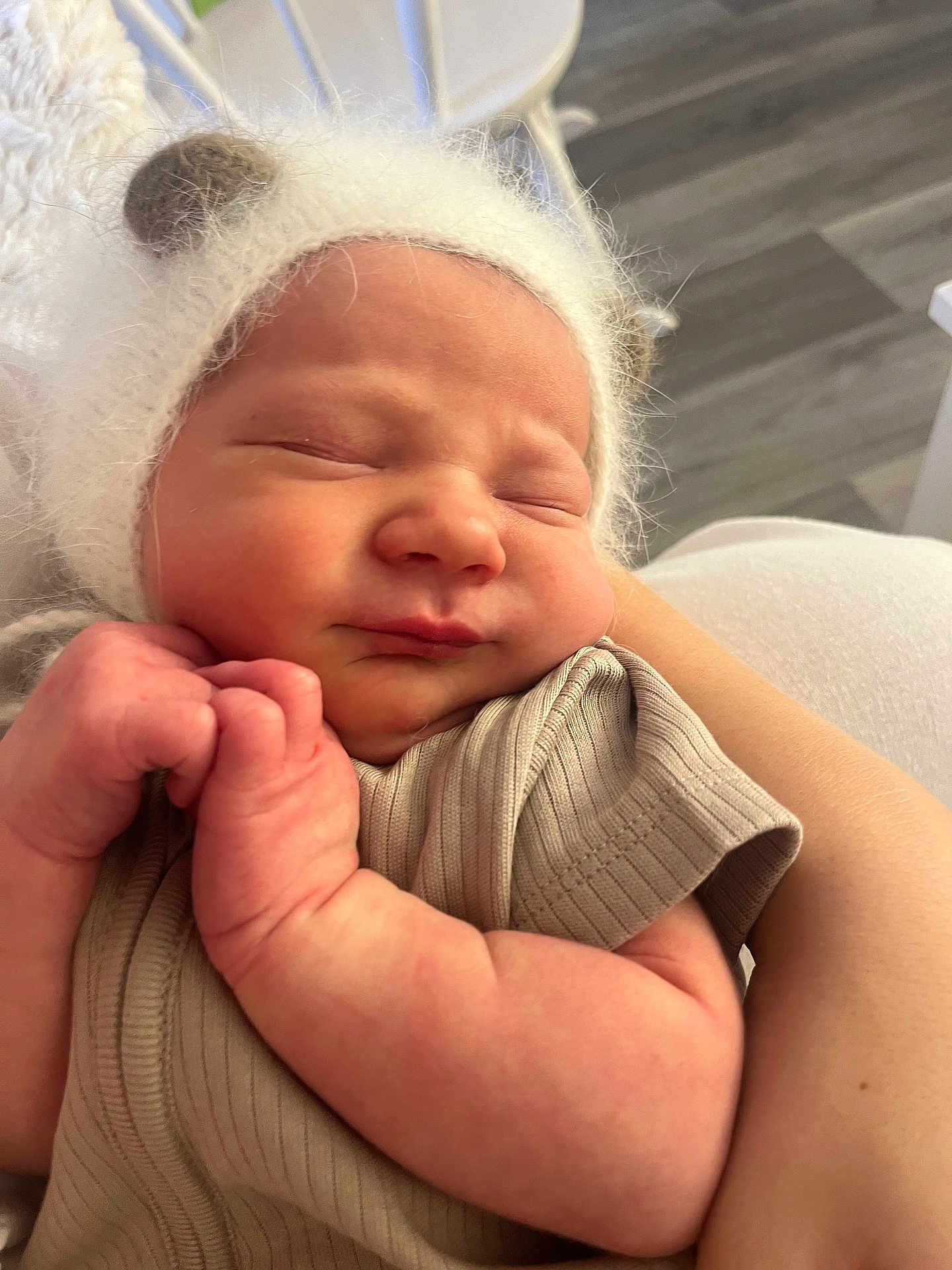 Roman is registered to the contest to win money with this photo: newborn, baby, infant, sleeping, hat, fuzzy, bear_ears, arm, skin, clothing, closeup, indoor, person, child, cute, peaceful, face, hand, soft, portrait