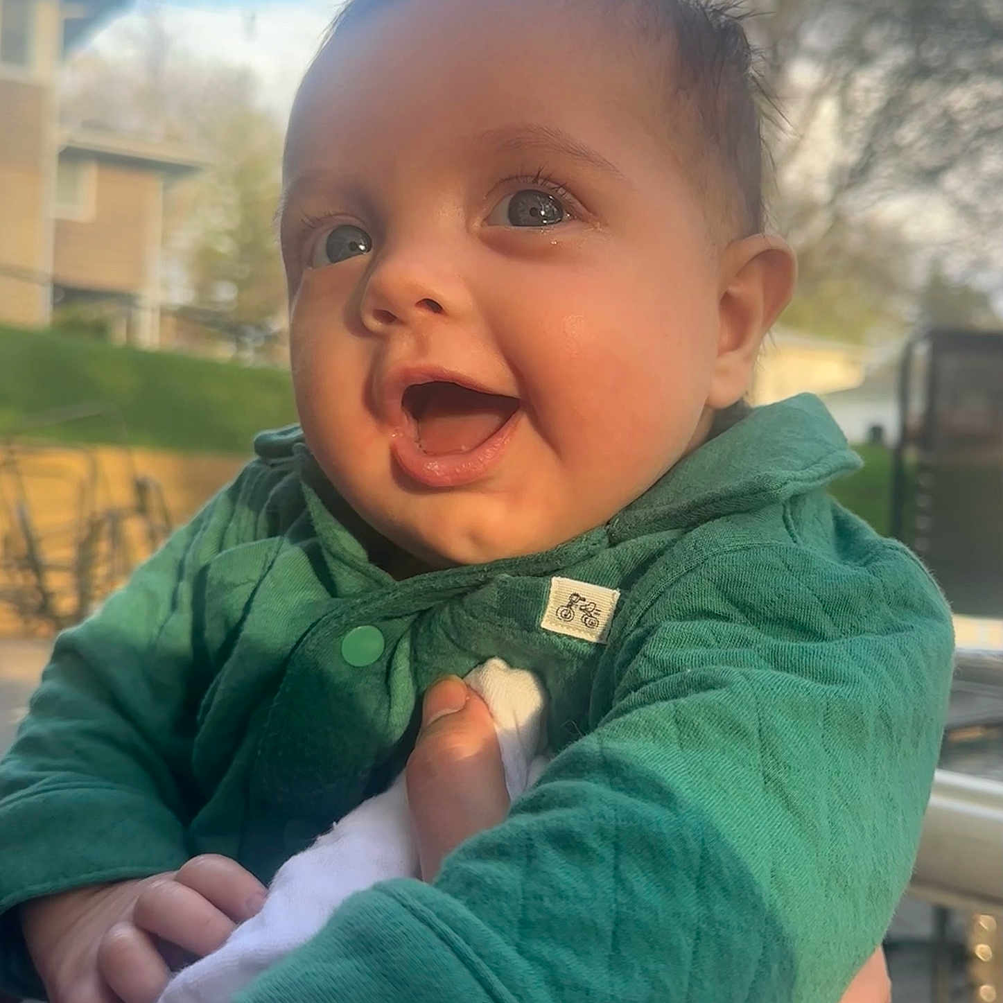 Elijah is registered to the contest to win money with this photo: baby, babylaughing, bodypart, city, clothing, coat, face, grass, happy, head, jacket, laughing, mouth, pants, person, photography, plant, portrait, smile, teeth