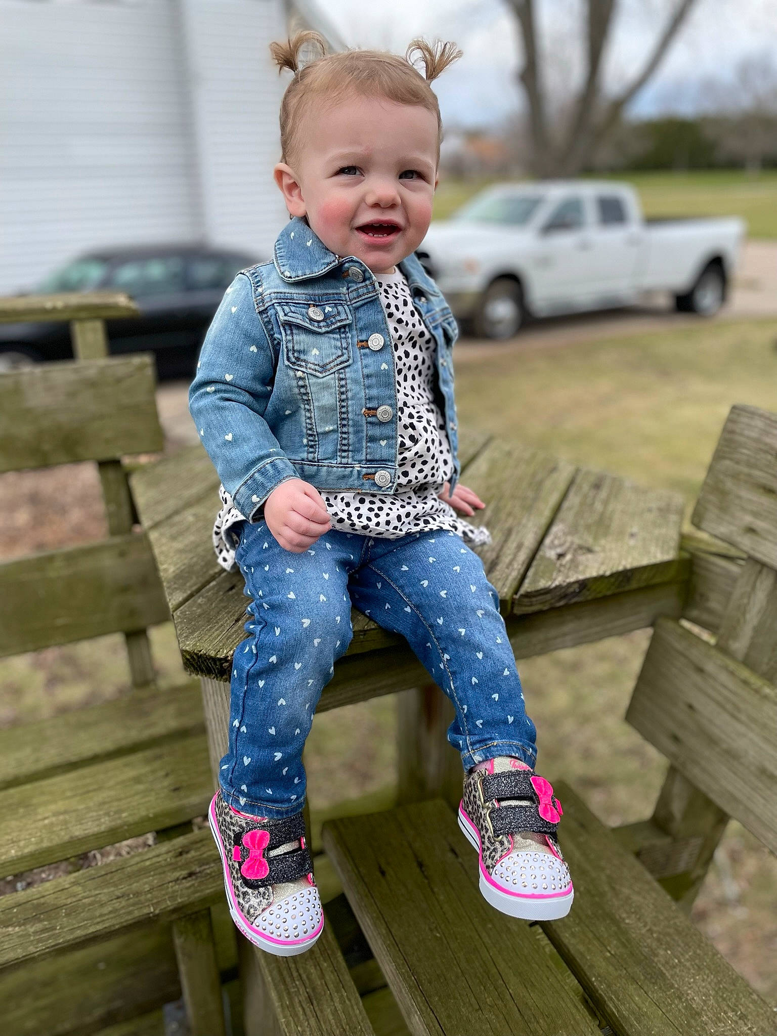 Gemma is registered to the contest to win money with this photo: baby, baby_toddler_clothing, car, eye, face, footwear, grass, happy, iris, people, person, pink, shoe, skin, sleeve, smile, street_fashion, tire, toddler, wheel
