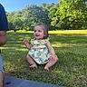 child, toddler, baby, smiling, sitting, outdoors, grass, park, garden, trees, nature, sunlight, blue_sky, dress, floral_pattern, barefoot, portrait, family, summer, happy