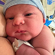 Daniel is registered to the contest to win money with this photo: newborn, baby, infant, face, skin, hospital, wristband, hat, closeup, resting, sleepy, person, child, arm, healthcare, newborn_baby, hospital_bed, soft_light, portrait, cute