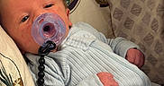 Daniel is registered to the contest to win money with this photo: baby, blue_clothing, child, clip, closeup, comfort, cute, face, hand, indoor, infant, newborn, onesie, pacifier, pattern, pillow, portrait, resting, sleepy, soft_fabric