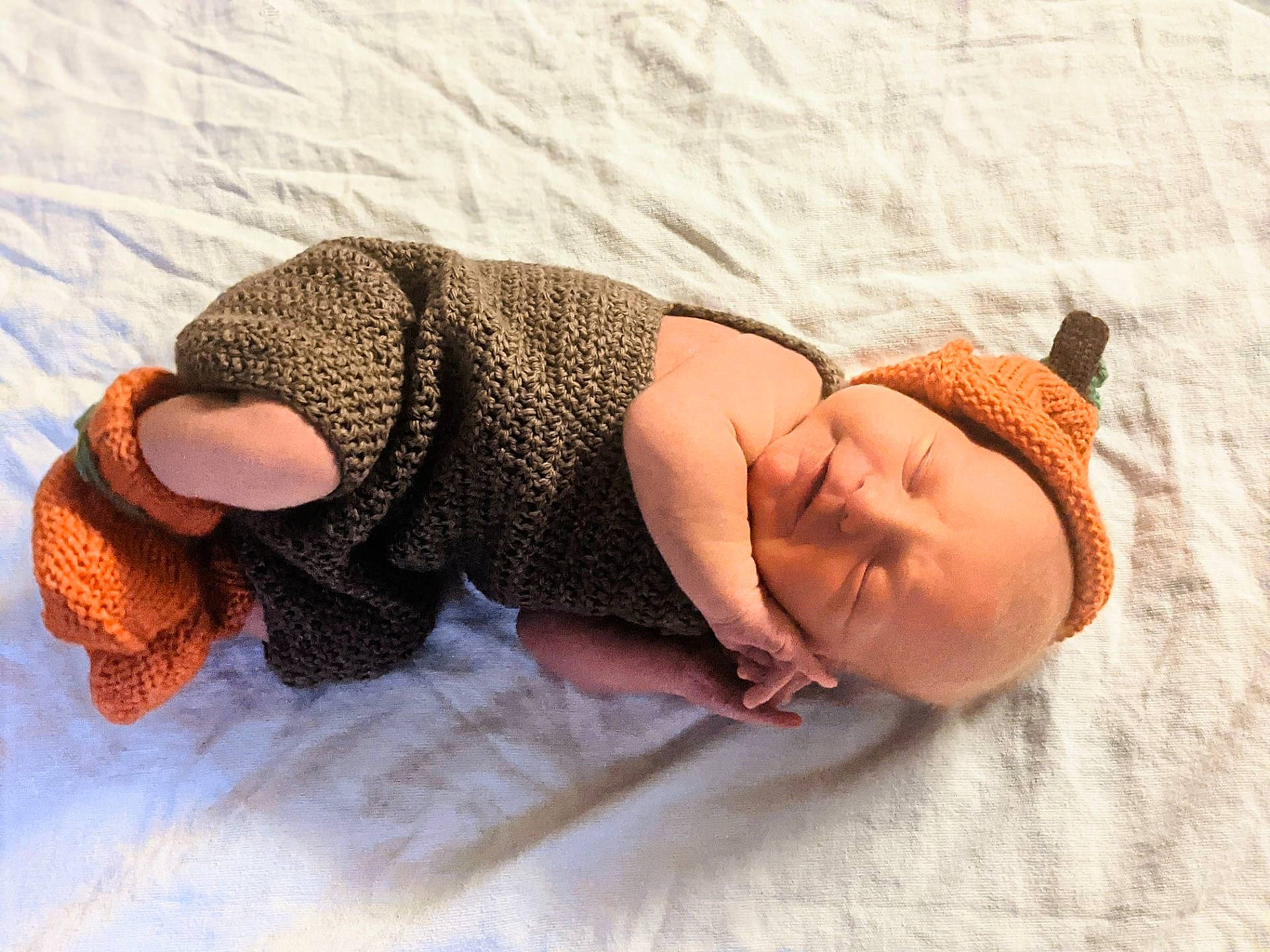 Callen is registered to the contest to win money with this photo: abdomen, arm, baby, comfort, elbow, fawn, finger, foot, head, headgear, human_body, human_leg, knee, leg, linens, pattern, person, skin, thigh, toddler