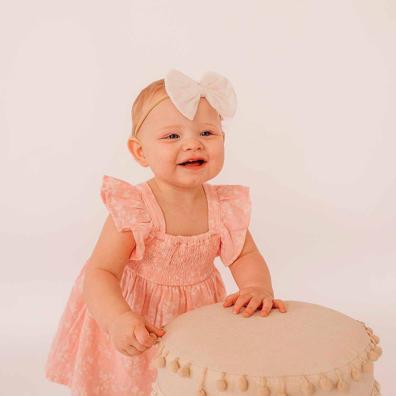 Blair is registered to the contest to win money with this photo: baby, bow, child, cute, fringe, furniture, girl, happy, headband, indoor, innocent, pink_dress, playful, portrait, smiling, standing, stool, studio, tassels, toddler