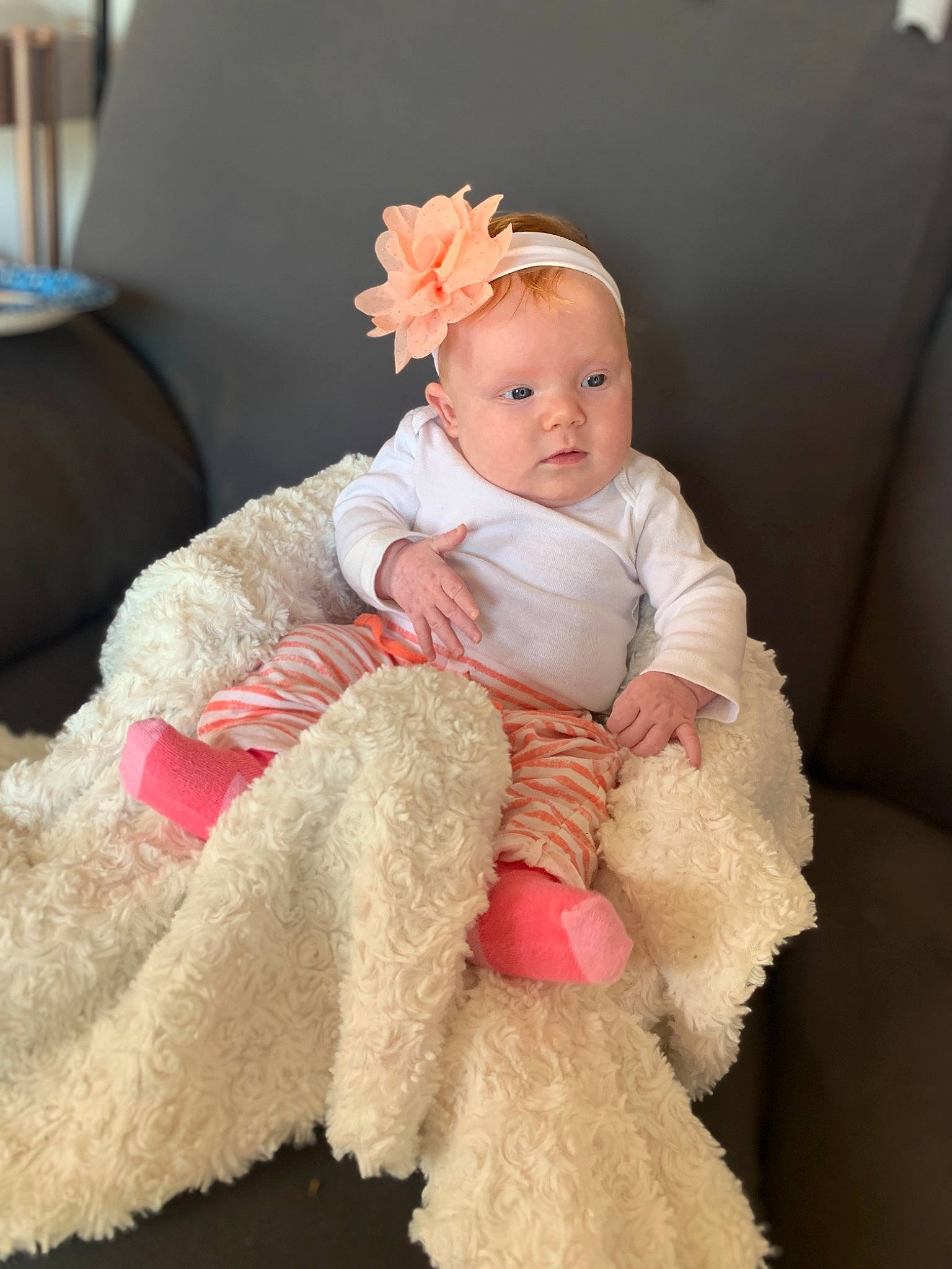 Evalyn joined the competition — help win amazing prizes! baby, baby_toddler_clothing, costume_accessory, embellishment, fur, hair_accessory, headband, headgear, headpiece, living_room, natural_material, peach, person, pink, rose, shoe, sock, toddler