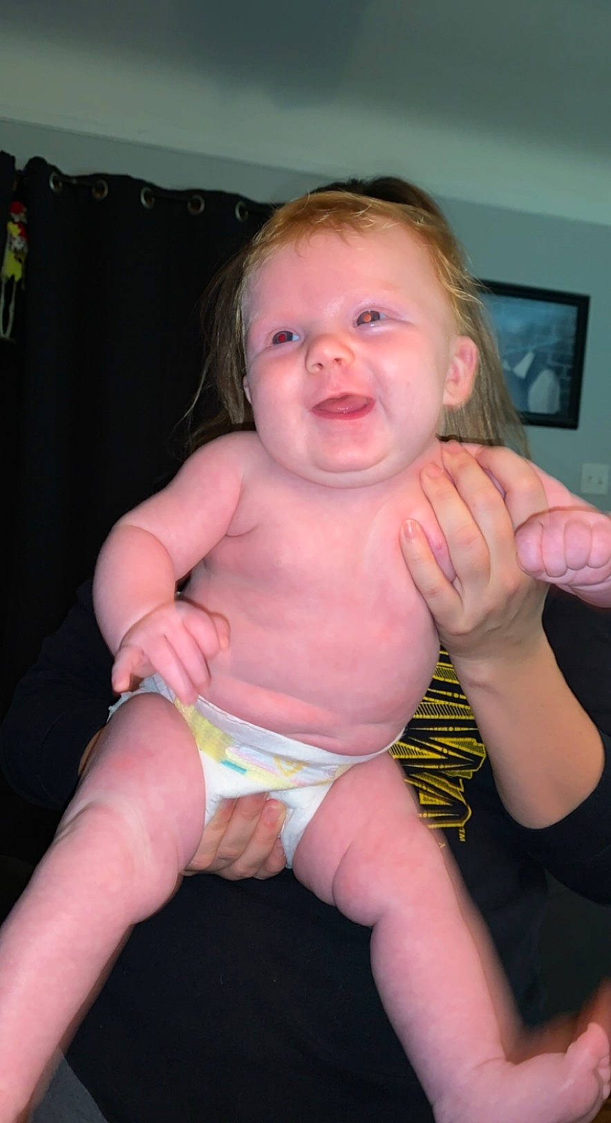 Evalyn is registered to the contest to win money with this photo: abdomen, baby_products, baby_toddler_clothing, cheek, chest, child, diaper, display_device, finger, hand, joint, muscle, nail, organ, person, skin, stomach, thumb, toddler, toe