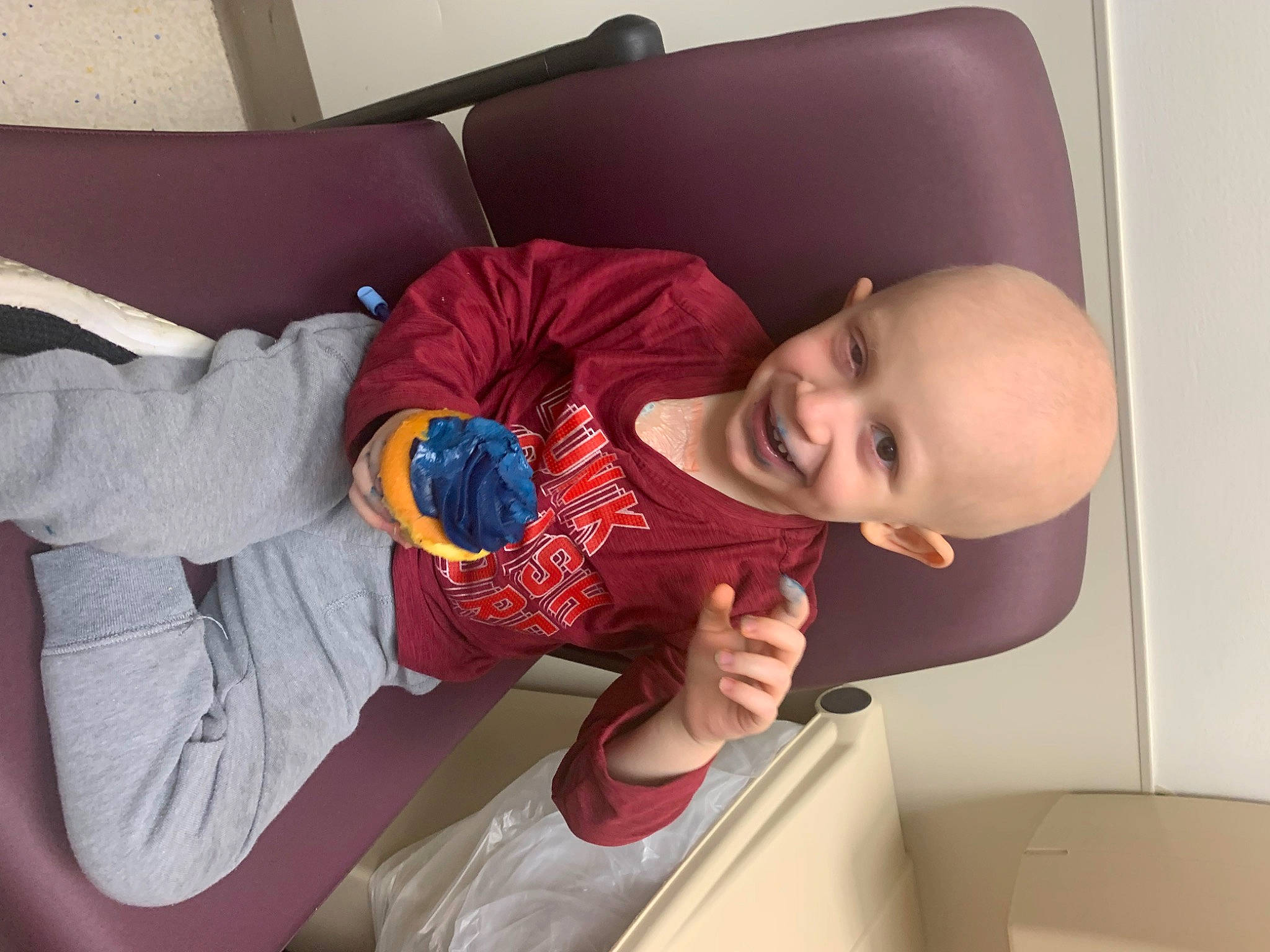 Jaxen is registered to the contest to win money with this photo: arm, baby, baby_toddler_clothing, child, comfort, couch, elbow, electric_blue, finger, hand, joy, knee, lap, person, room, sitting, sleeve, smile, t_shirt, thigh