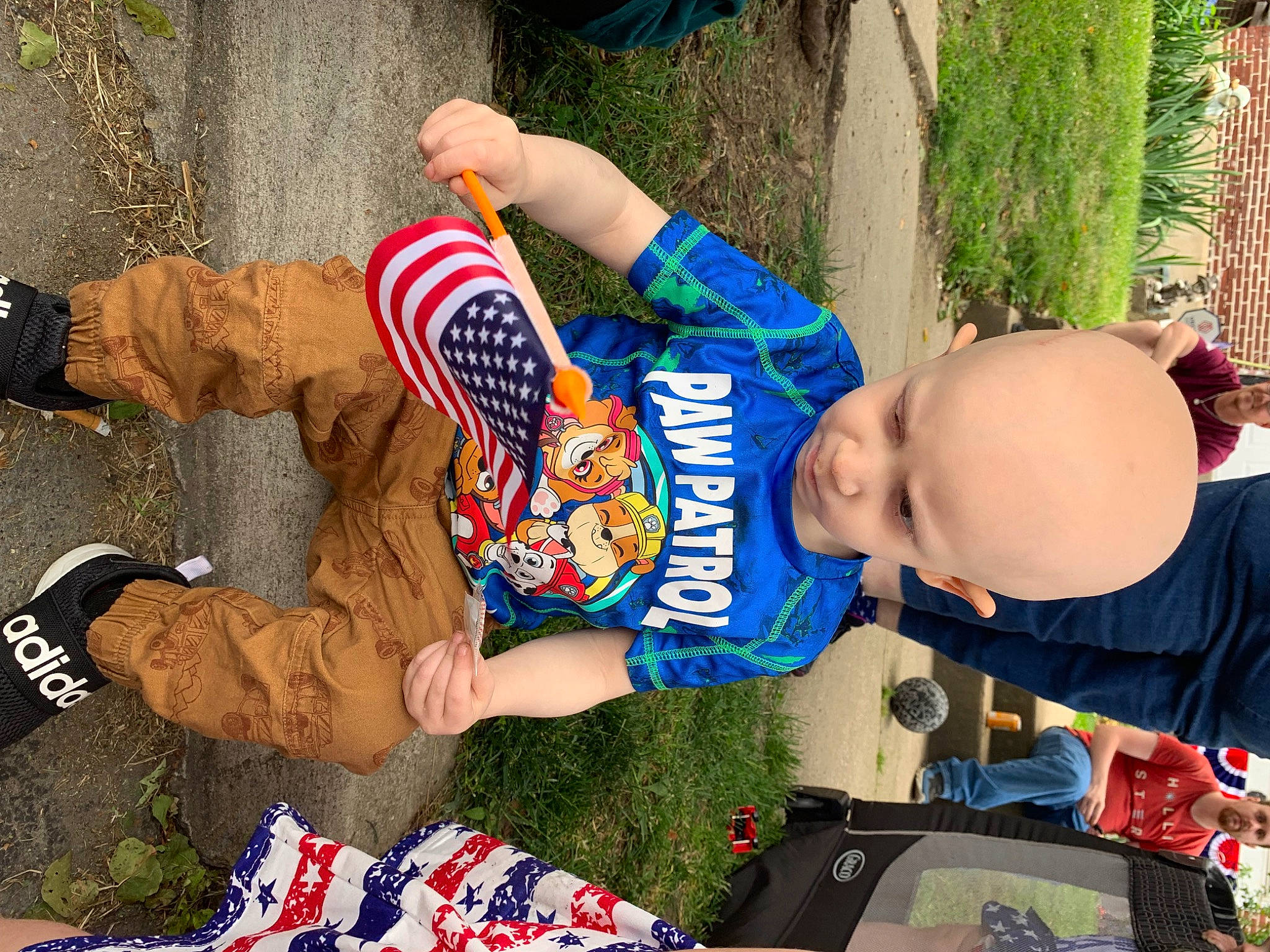 Jaxen is registered to the contest to win money with this photo: arm, baby, blue, child, community, competition_event, event, flag_of_the_united_states, fun, grass, happy, headwear, human_leg, leisure, person, plant, recreation, sock, t_shirt, thigh