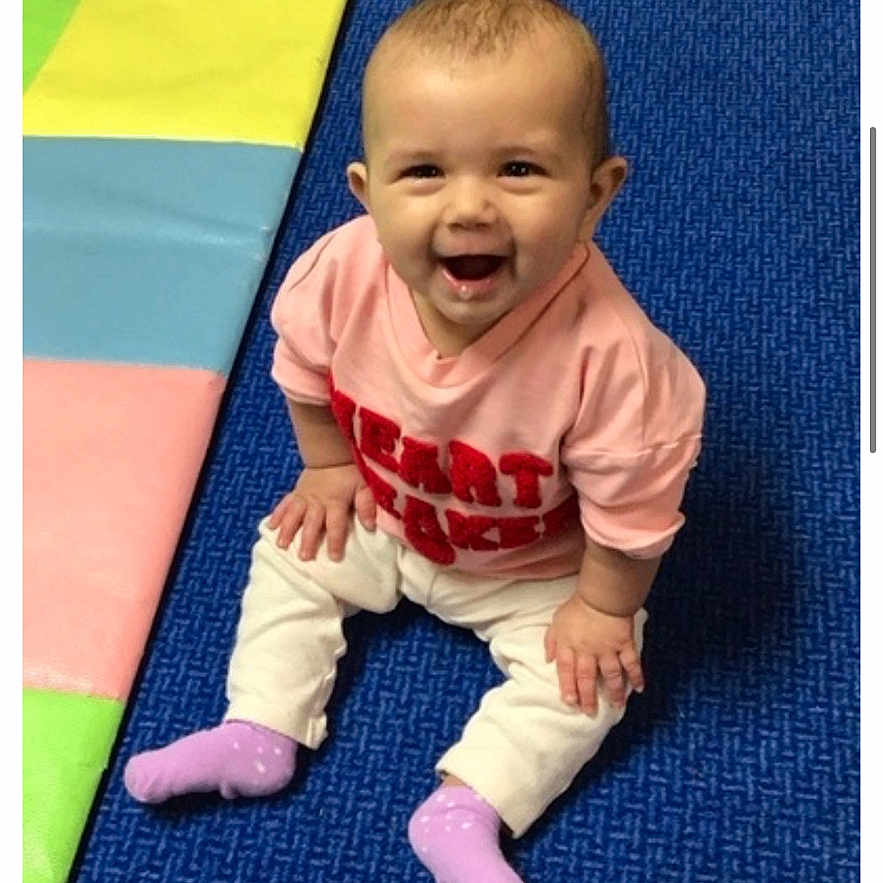 Scarlytte joined the competition — help win amazing prizes! baby, carpet, child, clothing, cute, expression, face, floor, happy, head, indoor, infant, person, pink_shirt, play_mat, purple_socks, sitting, smiling, toddler, young_child
