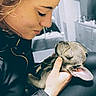Lillie Bean is registered to the contest to win money with this photo: woman, person, puppy, dog, floppy_ears, sleeping, pet, animal, portrait, close_up, indoors, home, kitchen, hand, holding, black_clothing, wrinkles, cute, cozy, photography