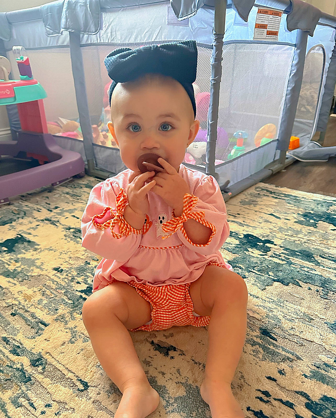 Sadie is registered to the contest to win money with this photo: abdomen, baby, baby_toddler_clothing, barefoot, child, chin, flooring, foot, fun, happy, human_leg, knee, leisure, person, pink, sitting, skin, thigh, toddler, trunk