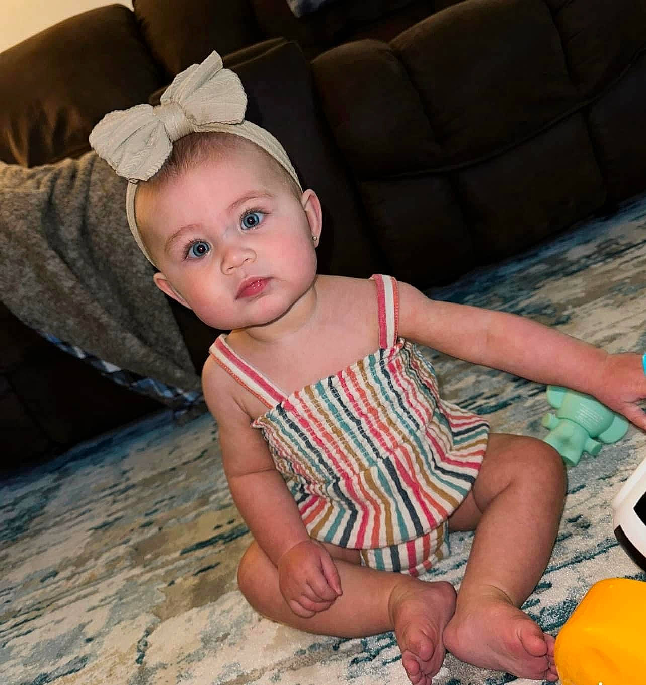 Sadie joined the competition — help win amazing prizes! baby, baby_toddler_clothing, ball, barefoot, calabaza, child, comfort, couch, flash_photography, flooring, fun, gourd, human_leg, iris, pattern, person, sitting, skin, sleeve, thigh