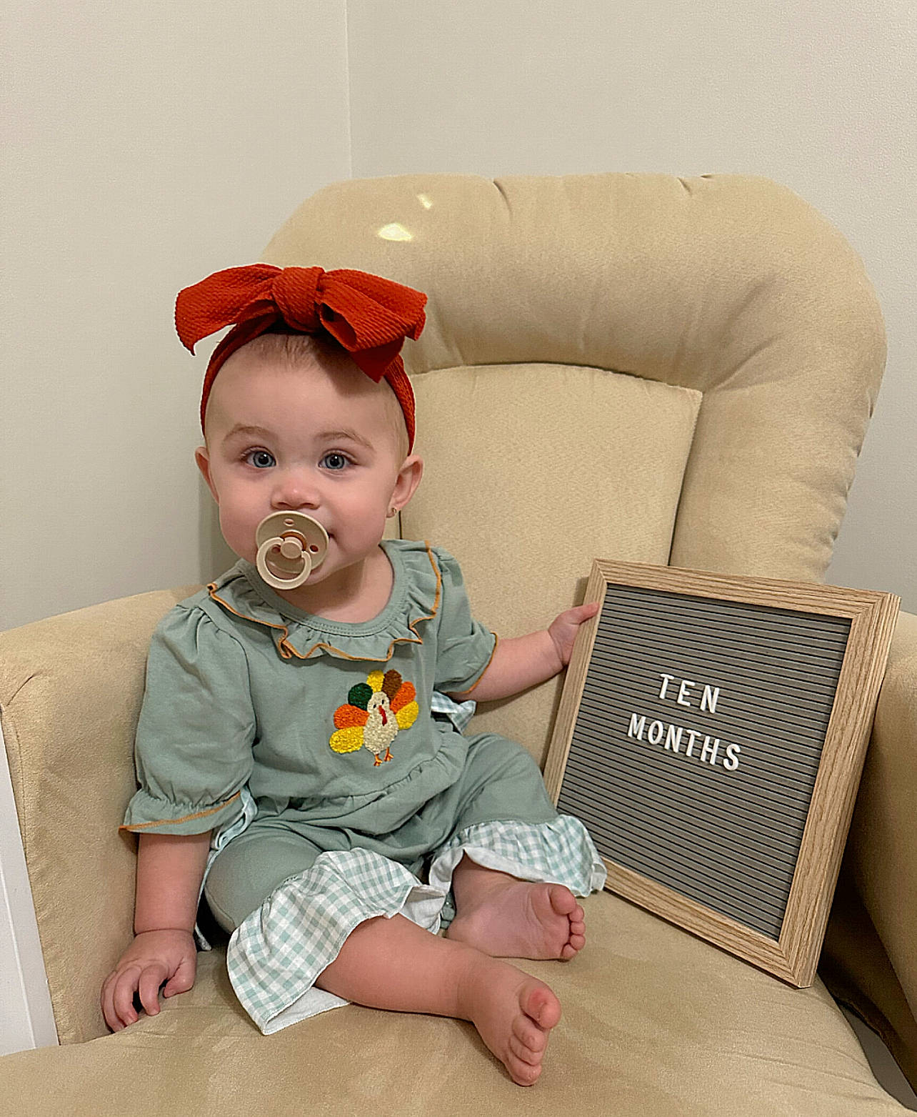 Sadie joined the competition — help win amazing prizes! baby, baby_toddler_clothing, barefoot, child, comfort, costume_hat, face, fashion_accessory, foot, head, human_leg, lap, pattern, person, room, sitting, sleeve, sock, t_shirt, thigh
