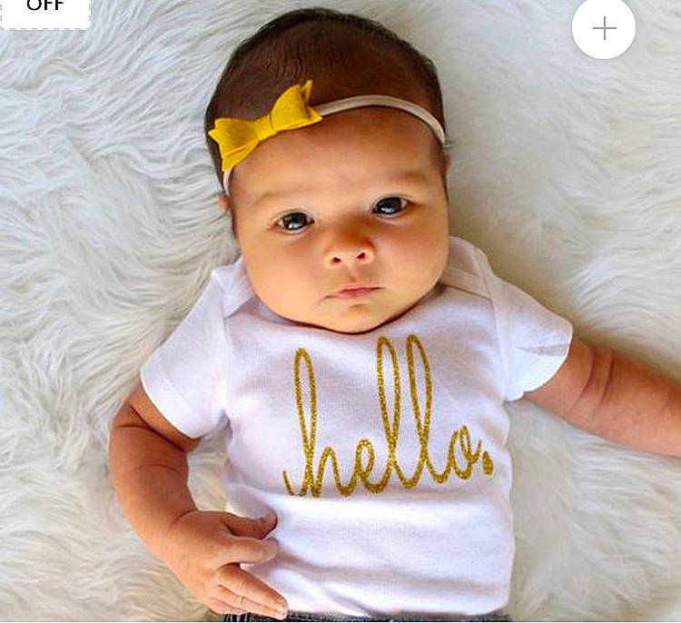 Ana joined the competition — help win amazing prizes! baby, baby_products, baby_toddler_clothing, child, child_model, clothing, cool, face, hair_accessory, head, headband, headgear, headwear, outerwear, person, product, sleeve, smile, t_shirt, toddler