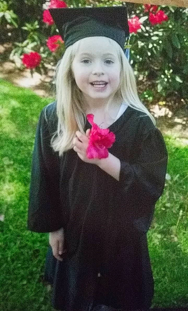 Makayla joined the competition — help win amazing prizes! blond, child, clothing, dress, fashion_accessory, flower, grass, hair, headgear, joy, lip, long_hair, outerwear, person, petal, pink, plant, sleeve, smile, spring