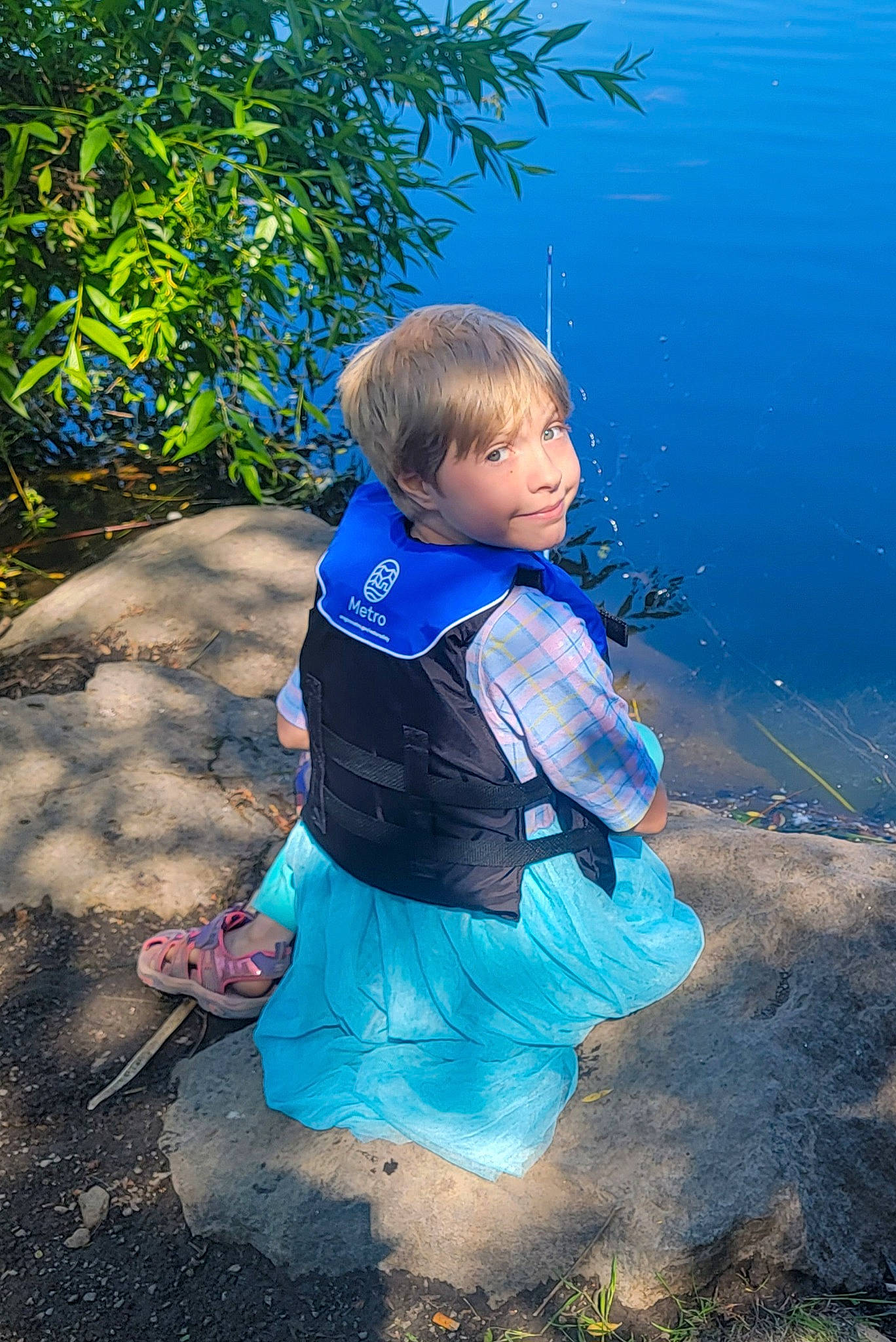 Makayla joined the competition — help win amazing prizes! azure, child, electric_blue, fun, grass, lake, landscape, leisure, ocean, people_in_nature, person, personal_protective_equipment, plant, recreation, shadow, sitting, soil, t_shirt, toddler, vacation