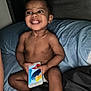 toddler, child, smiling, bed, pillow, smartphone, diaper, happy, indoors, person, skin, face, hand, furniture, technology, casual, young, cute, playful, expression